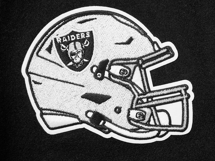 Close-up of the Raiders helmet patch on the sleeve of the varsity jacket.